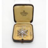 A white metal spinel set star brooch, approx diameter 3.5cm, weight 6.5gms Condition Report: