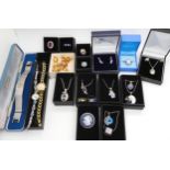 A collection of silver and costume jewellery to include a Wedgwood cherub brooch, silver gem set