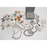 A collection of silver and white metal jewellery to include amber set items, two retro pendants