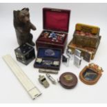 An eclectic mixed lot, comprising Black Forest-style bear taper holder, 33ft leather-cased tape