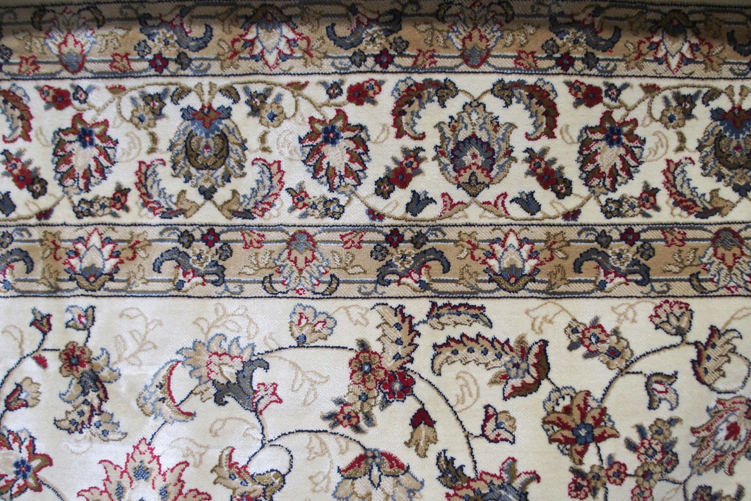A cream ground machine made Kashmiri rug with all-over floral design and flower head borders, - Image 5 of 6
