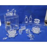 A collection of Swarovski crystal ornaments including pineapple, candleholders, assorted birds etc