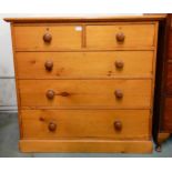 An early 20th century pine two over three chest of drawers with turned handles, 100cm high x 104cm