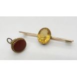 A 9ct gold fob seal and a yellow metal bar brooch set with a citrine, weight 9.5gms Condition