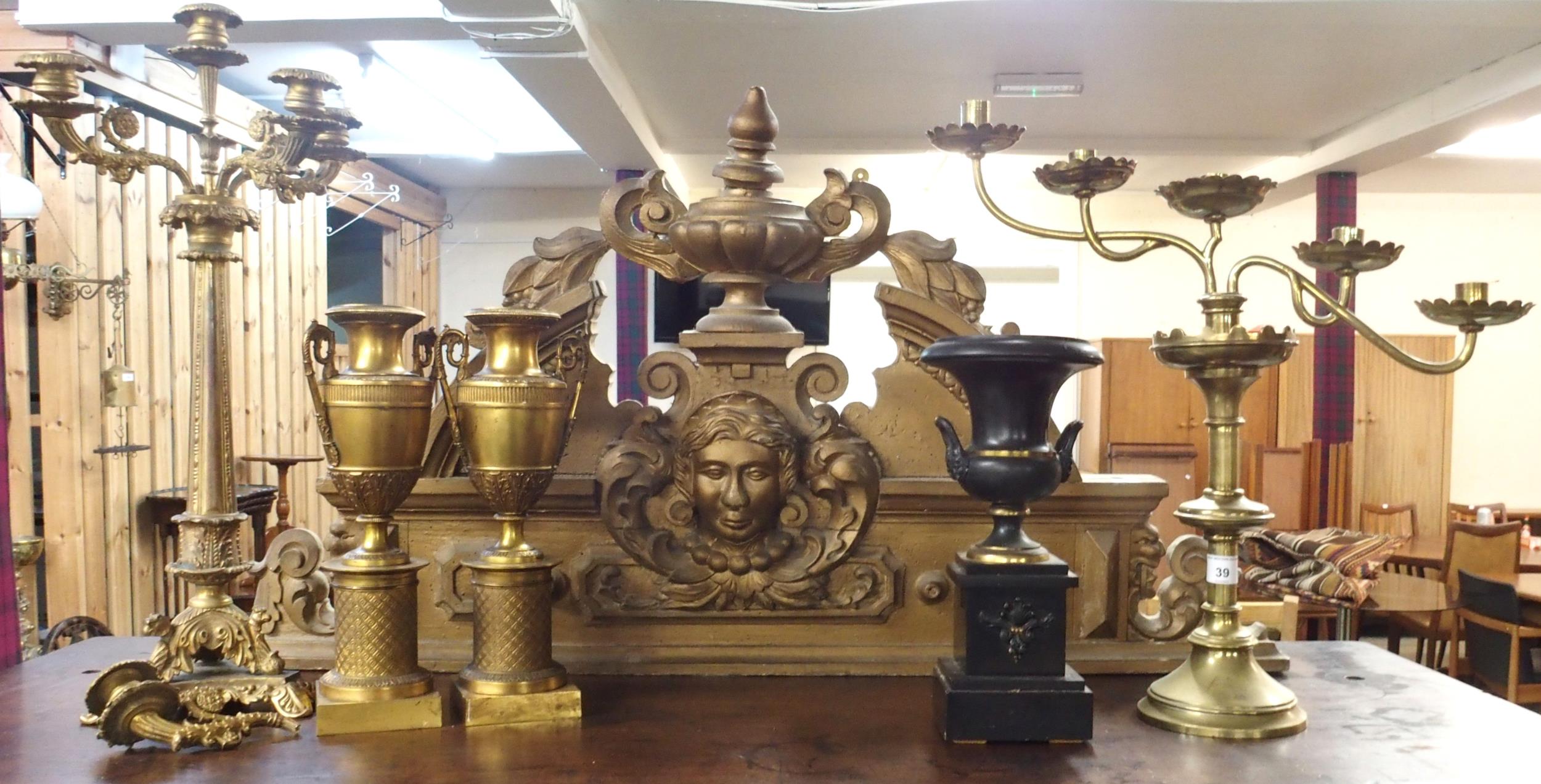A mixed lot to include gilt gesso surmount, two brass candelabrum, pair of brass urns on plinth