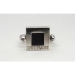 A white metal ring set with a square onyx stamped Bvlgari, approx size M, weight 5gms Condition