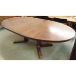 A mid 20th century Danish Skovby stained Afromosia teak oval extending dining table with single
