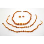 Three strings of amber coloured beads, probably all one necklace in the past, largest bead 16.7mm