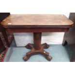 A Victorian mahogany fold-over tea table on octagonal pedestal terminating in scrolled quadrupedal