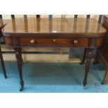 A Victorian mahogany single drawer fold-over tea table on turned supports terminating in casters (
