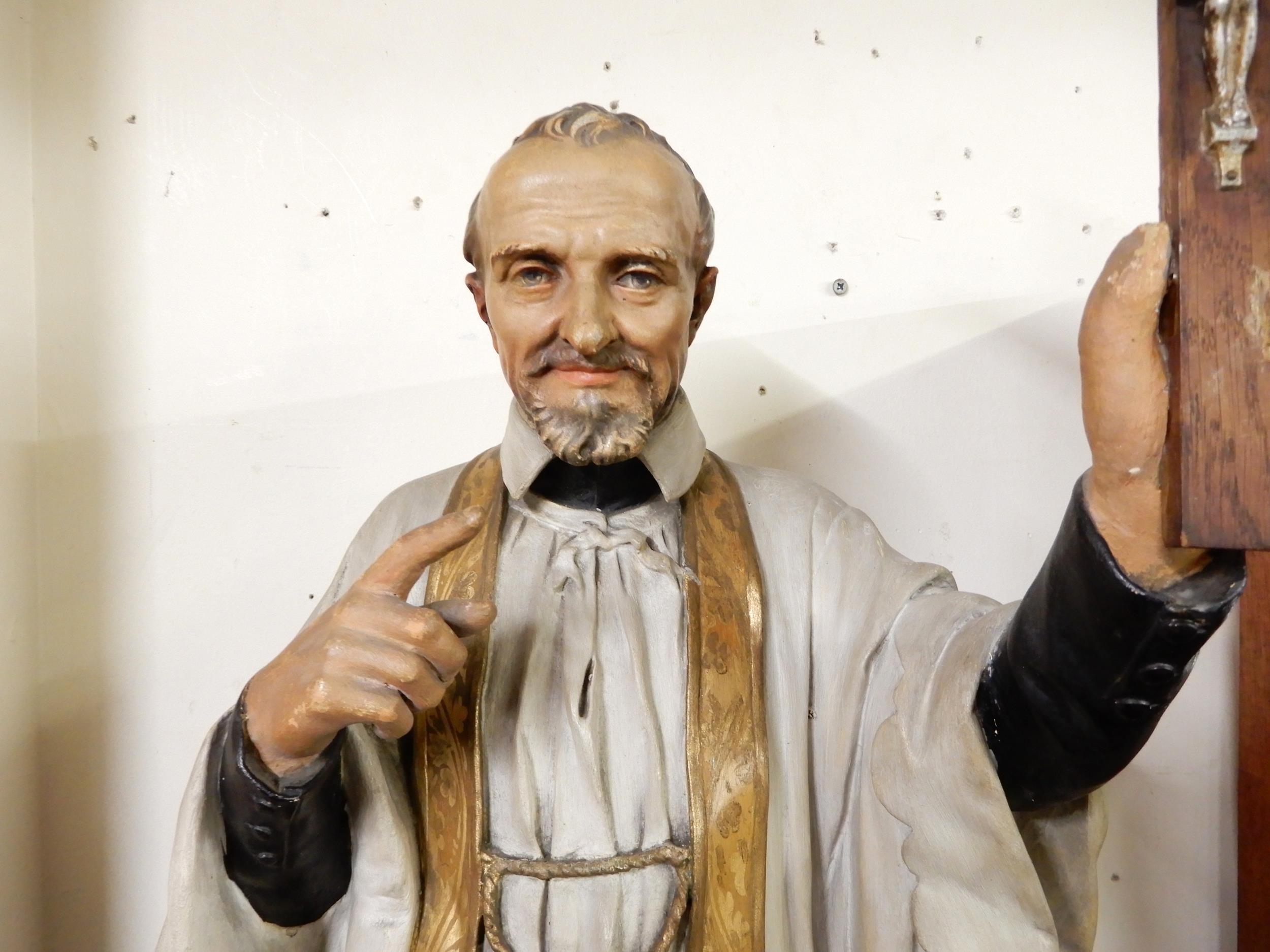A 20th century ecclesiastical statue of Saint Francis Xavier holding up a crucifix in reverence on - Image 2 of 4