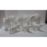 A group of white glazed Royal Doulton Images sculptures of elephants including Motherhood, two