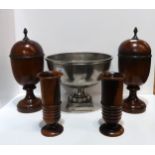 A pair of Theodore Alexander wooden urns and covers with patinated metal pineapple finials, a pair