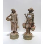 A pair of Royal Dux figures of a man and woman Condition Report:Man has broken arm and missing