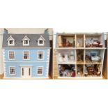 A 20th century three storey dolls house with assorted furniture and figures etc, 84cm high x 80cm