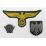 A WW2 German Third Reich Kriegsmarine chest eagle cloth patch, together with a tropical pith