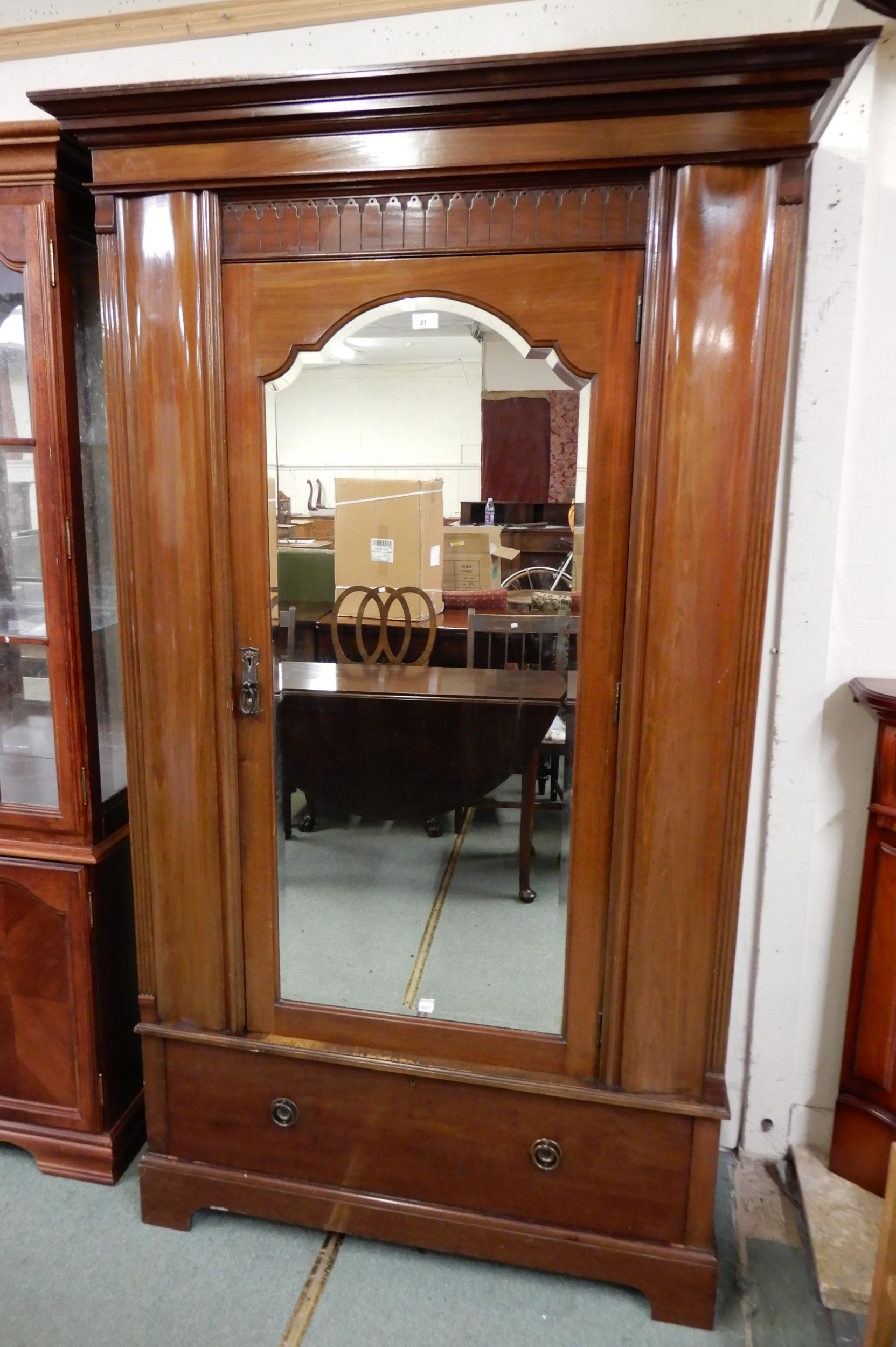 A late Victorian mahogany wardrobe with moulded cornice over single mirrored door over single drawer