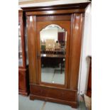 A late Victorian mahogany wardrobe with moulded cornice over single mirrored door over single drawer