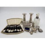 A collection of silver including a pair of silver candlesticks, modelled as Doric columns, on a