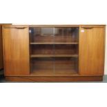 A mid 20th century teak bookcase with glazed central doors flanked by cabinet doors, 77cm high x
