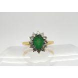 An 18ct gold emerald and diamond cluster, finger size O, weight 2.9gms Condition Report:Available