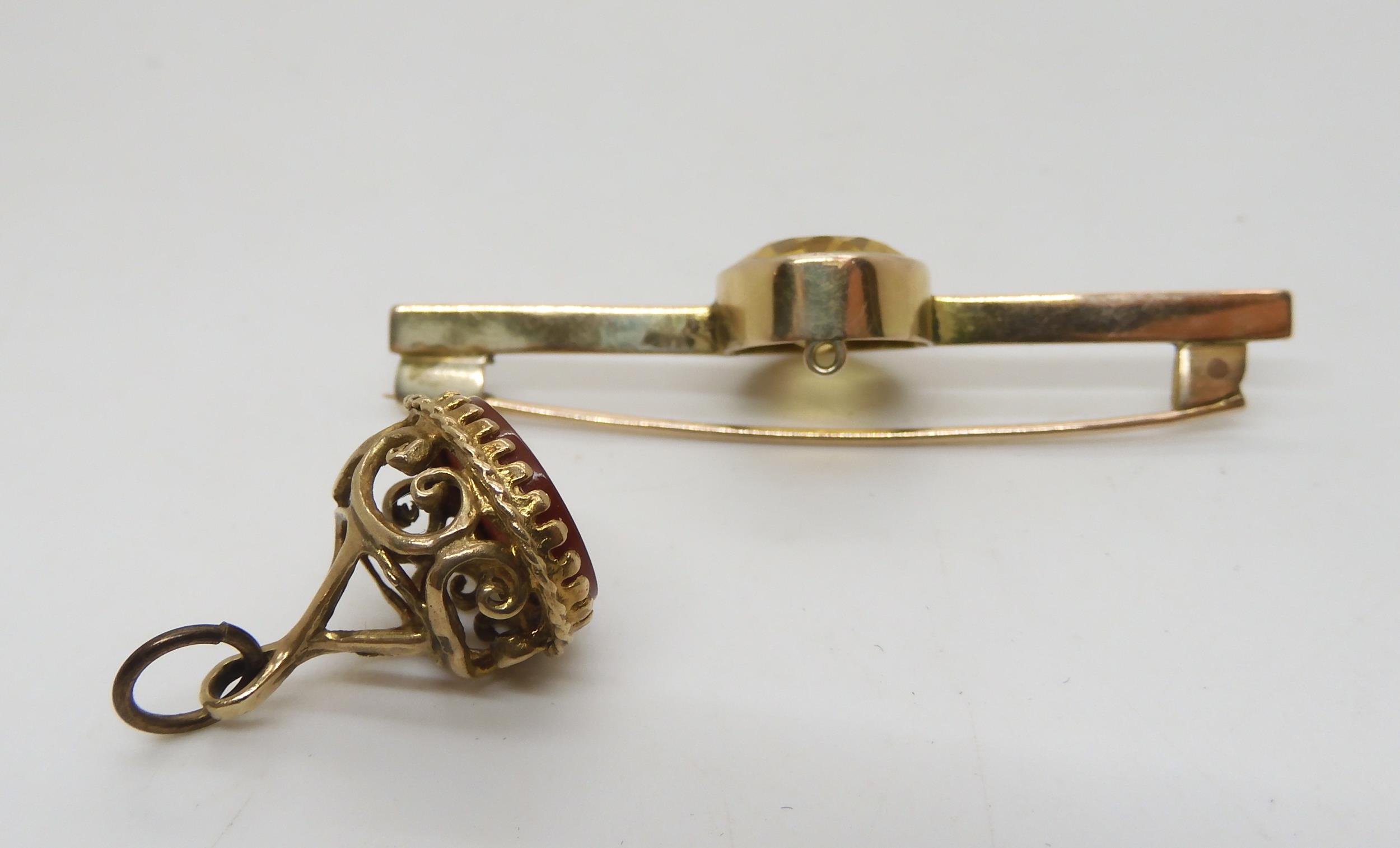 A 9ct gold fob seal and a yellow metal bar brooch set with a citrine, weight 9.5gms Condition - Image 2 of 2