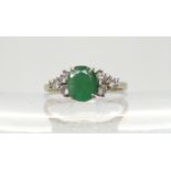 An 18ct white gold emerald and diamond cluster ring, finger size N, weight 2.6gms Condition Report:
