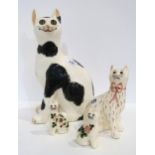 A large Griselda Hill pottery cat with glass eyes and three smaller examples Condition Report: