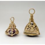Two 9ct gold decorative fob seal pendants, one set with a large smoky quartz, the other a purple