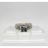A 9ct white gold, green and white diamond dress ring, set with estimated approx 1ct of brilliant cut