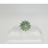 A 9ct gold emerald and diamond flower ring, finger size O1/2, weight 3.1gms Condition Report: