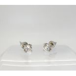 A pair of white metal mounted diamond stud earrings, set with estimated approx 0.33cts each,