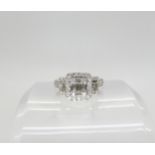 A 14k white gold ring set with estimated approx 0.80cts of baguette and brilliant cut diamonds,