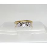 An 18ct gold three stone diamond illusion set ring, set with estimated approx 0.25cts of brilliant