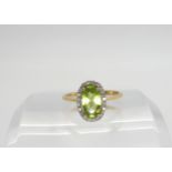 A 9ct gold peridot and diamond cluster ring set with estimated approx 0.10cts of brilliant cut