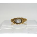 A 22ct gold Victorian mourning ring with plaited hair under glazed panel, Hallmarked London 1848,