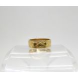 An 18ct gold wedding ring with heart motif, finger size N1/2, weight 4.7gms Condition Report: