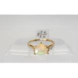 A 9ct gold trilliant cut Ethiopian opal, and diamond accent ring, with 'As new' tags and Gemporia