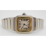 A LADIES CARTIER SANTOS GALBEE WATCH in gold and stainless steel, with cream dial, black Roman