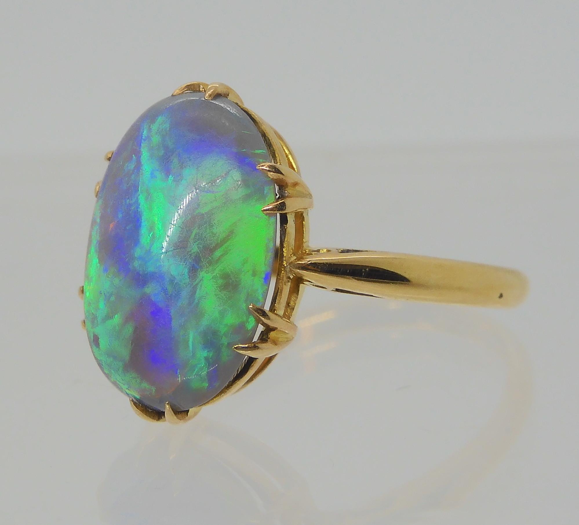 AN OPAL RING AND OTHER ITEMS The solid black opal has lively green, purple and blue colour play, and - Image 5 of 15