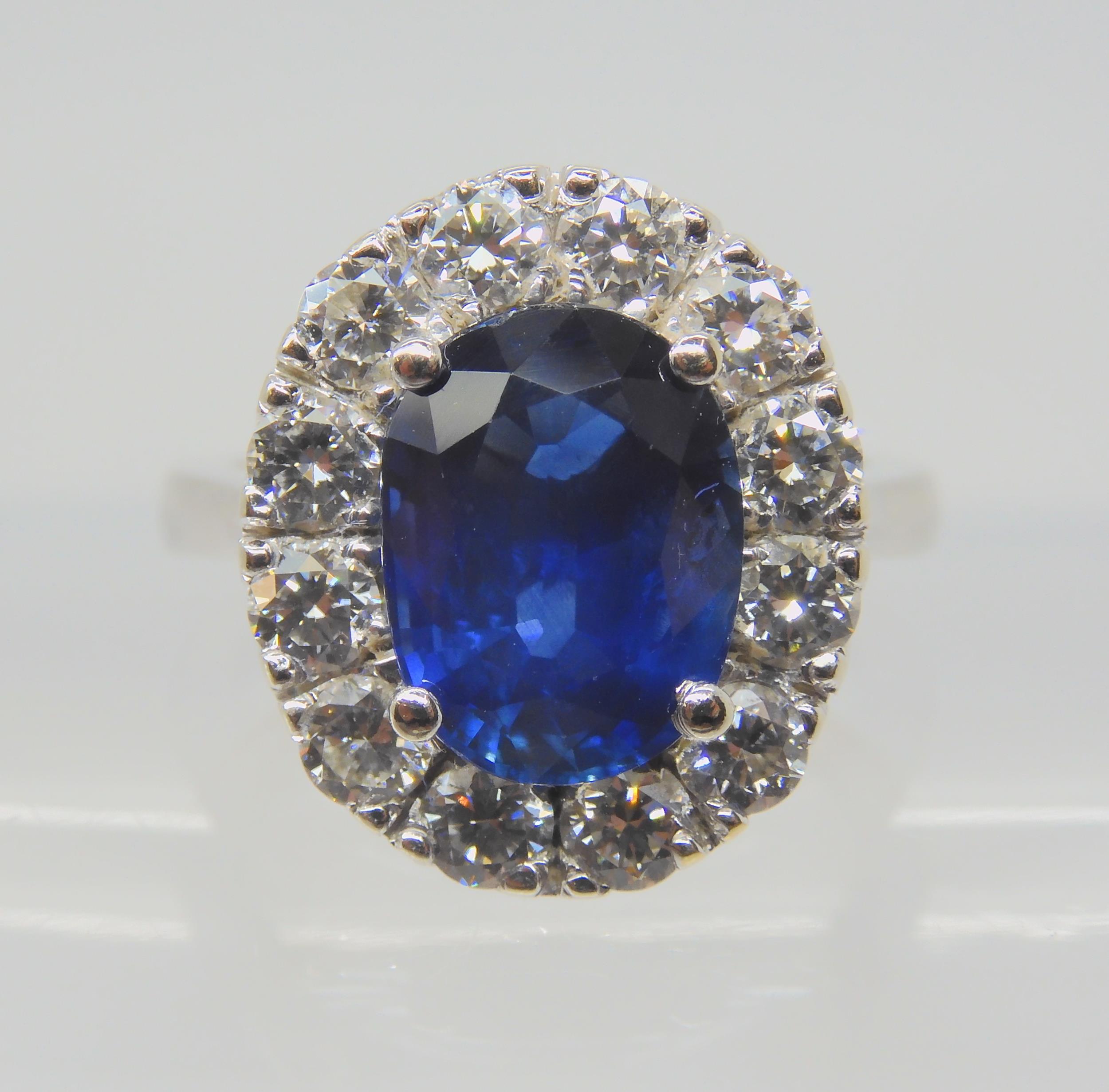 A SAPPHIRE AND DIAMOND CLUSTER RING set throughout in 18ct white gold, set with an oval mixed cut - Image 5 of 9