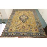 A LARGE MUSTARD GROUND HERIZ RUG with dark blue central medallion, floral pattern ground and light