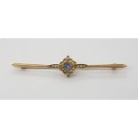 A 15CT PEARL AND BLUE GEM BROOCH the milgrain flower setting is set with split pearls and a blue