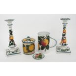 A PAIR OF ROBERT HERON AND SONS WEMYSS CANDLESTICKS painted with apples, 30c high, a similarly