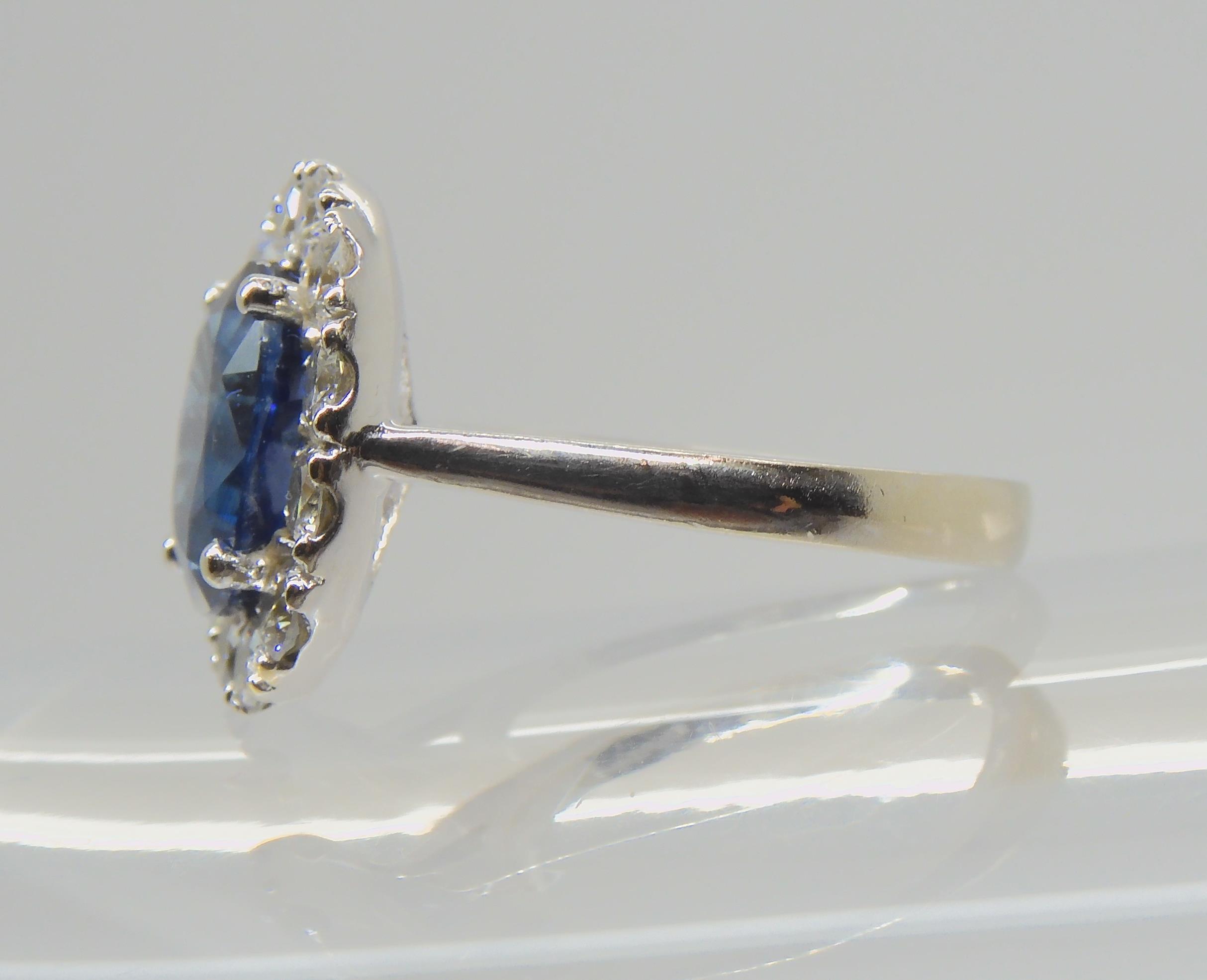 A SAPPHIRE AND DIAMOND CLUSTER RING set throughout in 18ct white gold, set with an oval mixed cut - Image 9 of 9