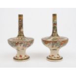 A PAIR OF SATSUMA COMPRESSED SLENDER VASES painted with panels of figures above butterflies and