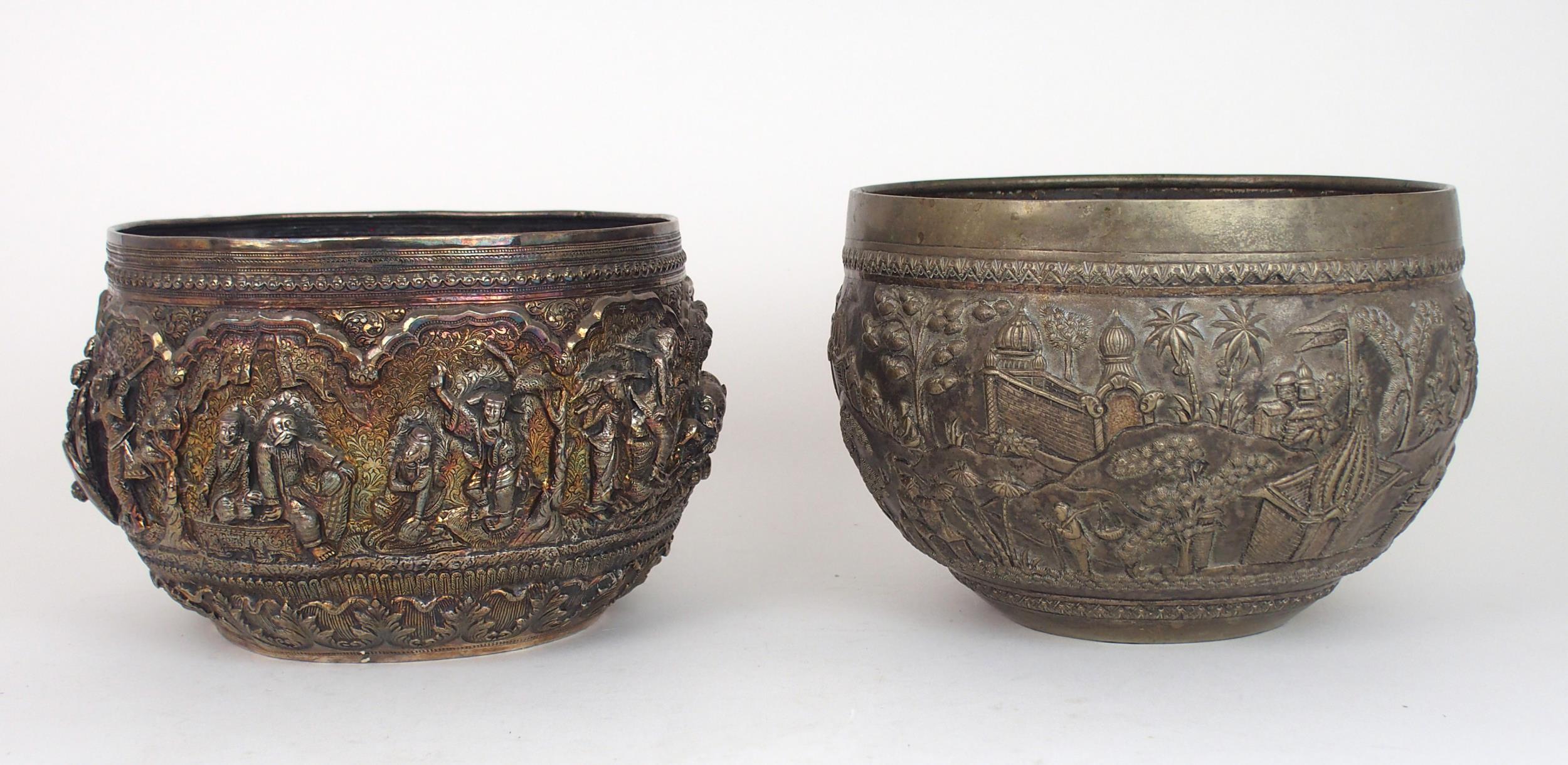 A BURMESE SILVER BOWL of rounded form, with profusely embossed and repousse work of villagers,