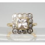 A DIAMOND AND PINK GEM SET RING the square head is set with estimated approx 0.48cts of brilliant