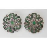 A PAIR OF EMERALD AND DIAMOND BROOCHES the gems set into white metal mounts with yellow metal pins
