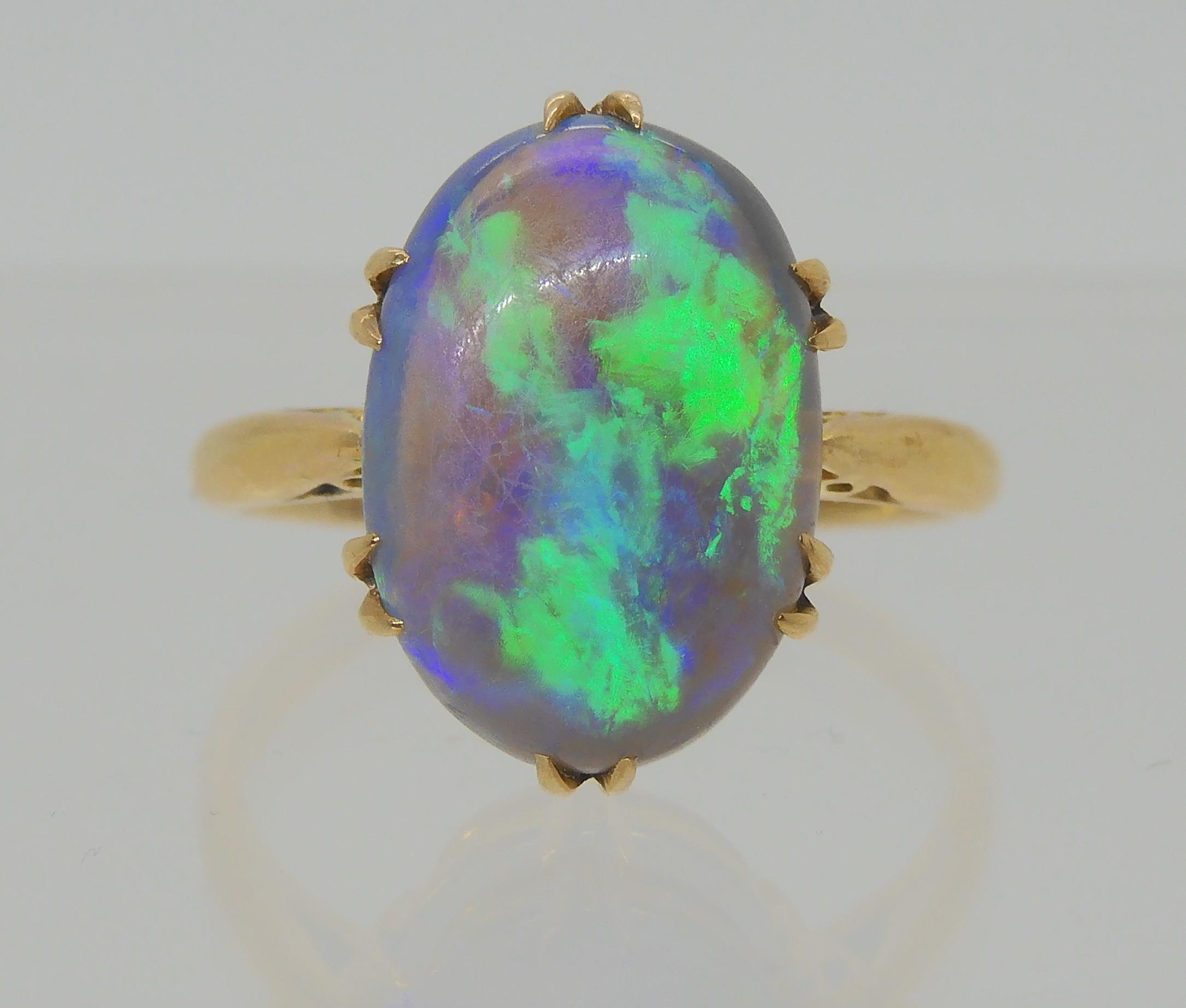 AN OPAL RING AND OTHER ITEMS The solid black opal has lively green, purple and blue colour play, and - Image 2 of 15